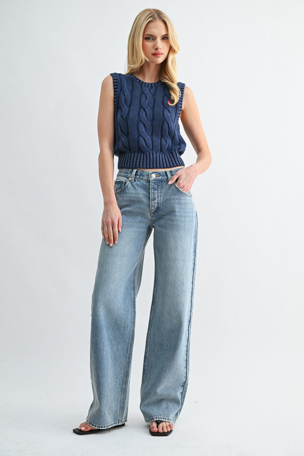 Front view of woman wearing 90s low-rise baggy wide-leg denim jeans