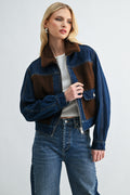 Model wearing two-tone dark wash denim jacket with warm sherpa lining