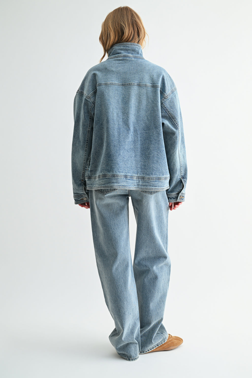 Back view of oversized mock-neck denim jacket in heavy vintage denim