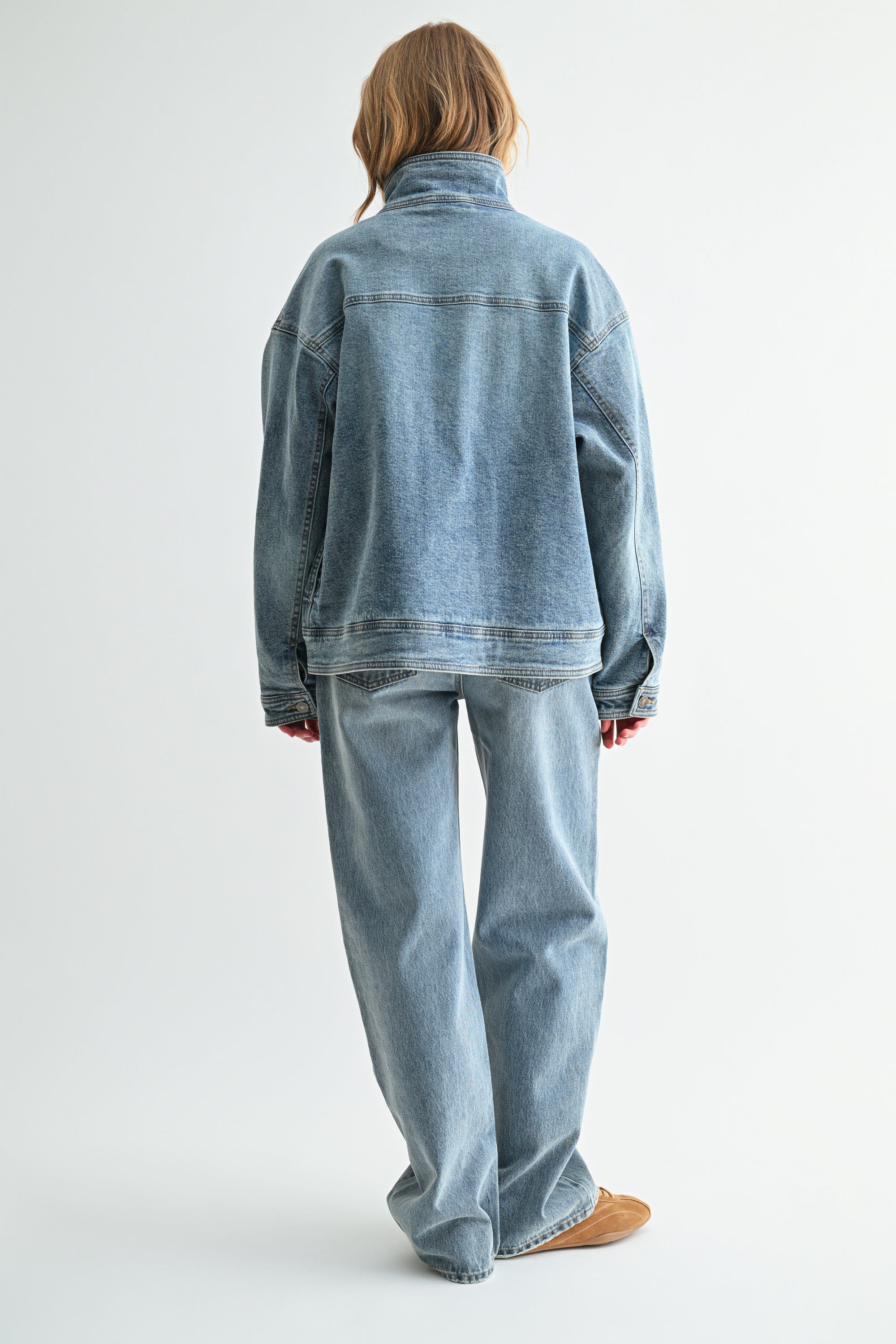 Back view of oversized mock-neck denim jacket in heavy vintage denim