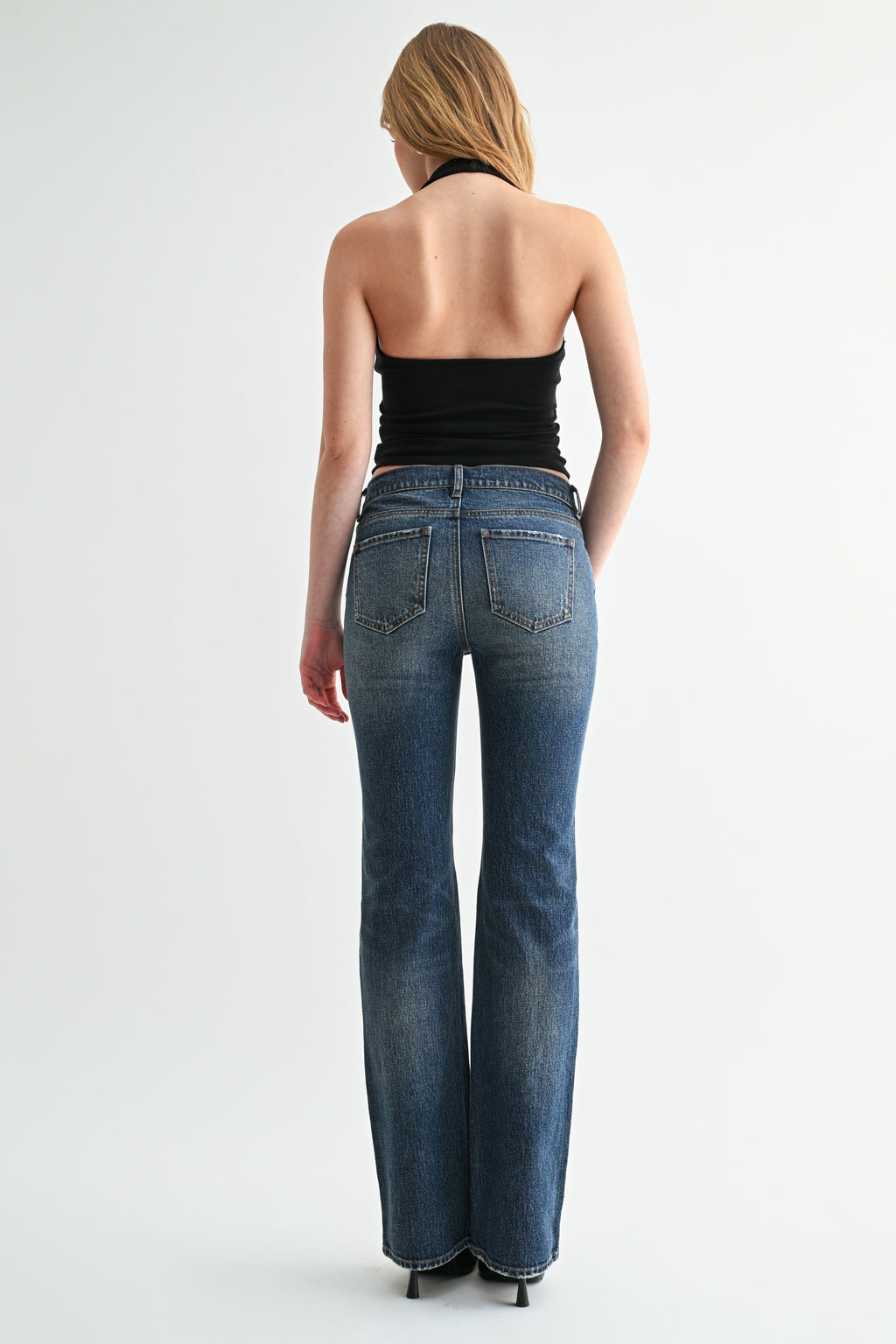 Full-length shot showing subtle leg flare on mid-rise bootcut jeans