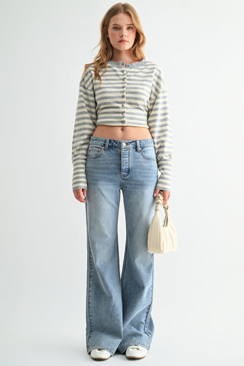 Front view of woman wearing high-rise loose flare jeans in premium denim