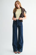 Front view of woman wearing high-rise straight-leg jeans with front patch pockets
