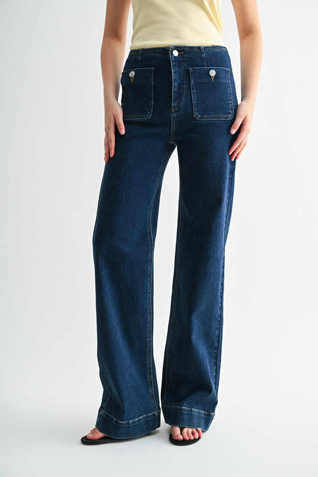 Side profile shot showing classic straight-leg silhouette in premium denim