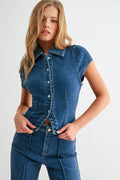 Front view of woman wearing seamed tailored denim button-down shirt